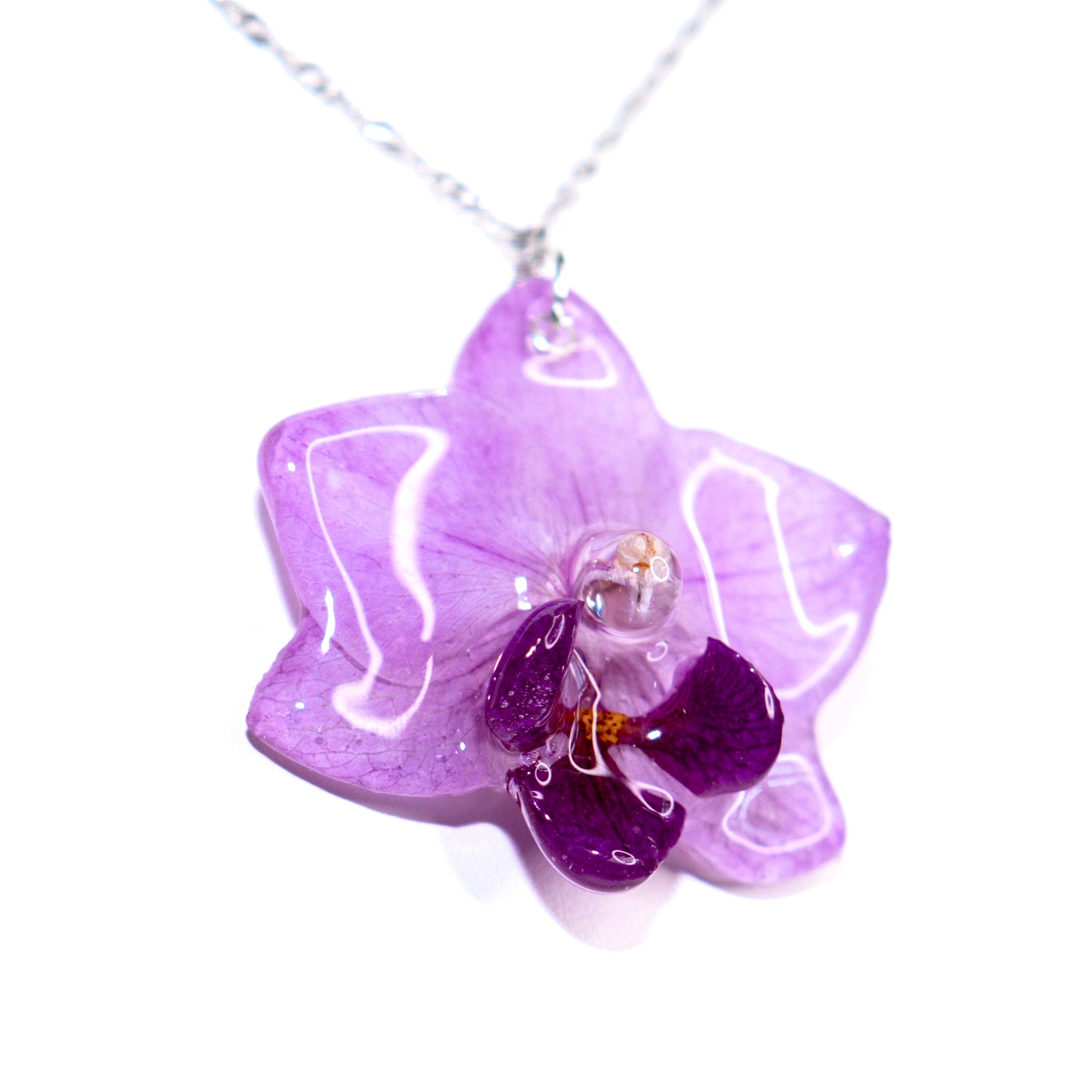 Purple flower-shaped pendant on a white background